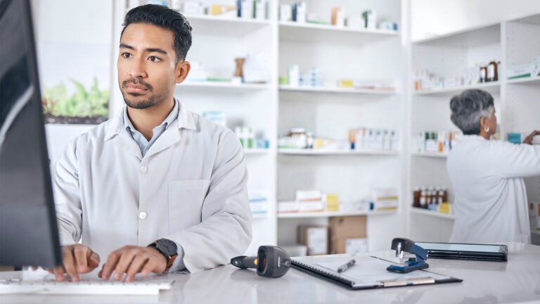 Pharmacy professional working at computer