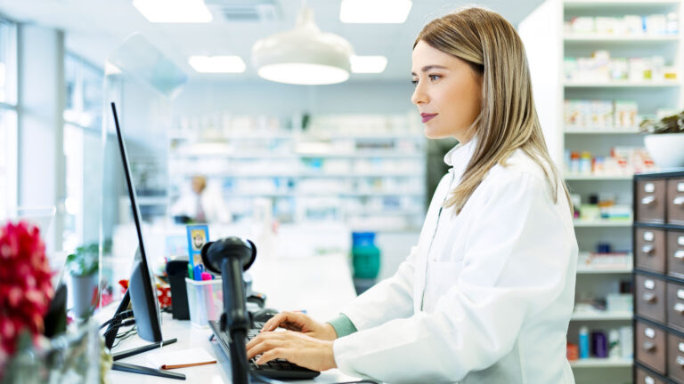 Pharmacy professional working on computer
