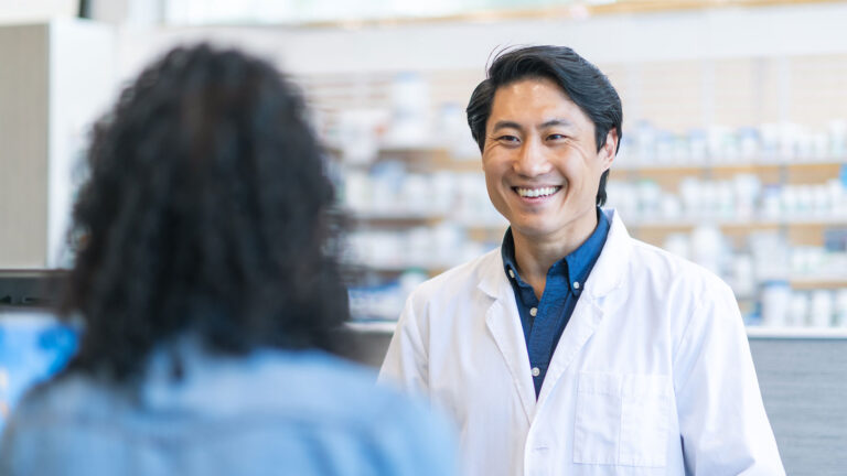 Pharmacy professional helping patient at the pharmacy counter