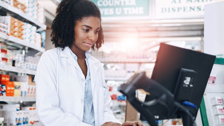 Pharmacy professional working on a computer