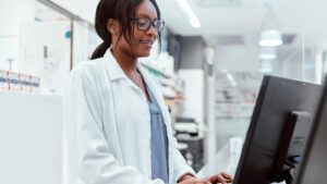 Pharmacy professional on computer in the pharmacy