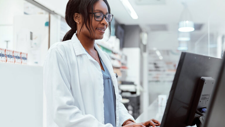 Pharmacy professional on computer in the pharmacy