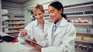 Two pharmacy professionals working together in the pharmacy
