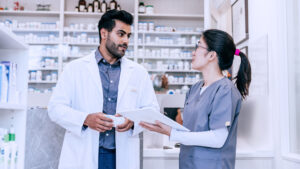 Pharmacy team member working with other healthcare professional in the pharmacy
