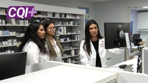 Licensee Vishranti Pandya and pharmacy team members looking at computer in pharmacy